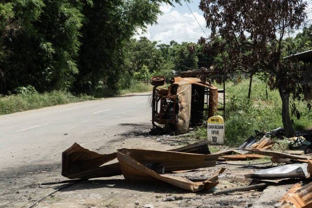 Manipur Violence - Road damage and burned vehicle visual used for Manipur crisis context from the CWI local archive.